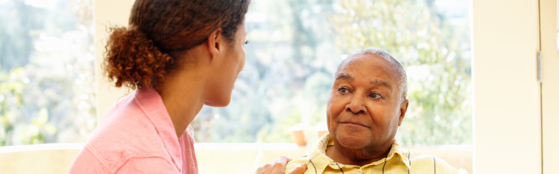 aide and elderly man talking