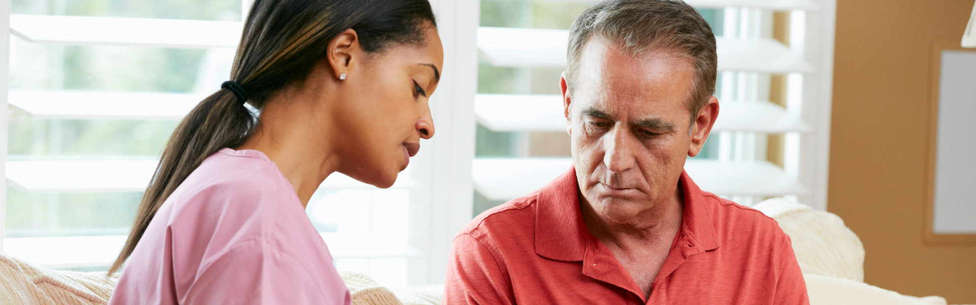 aide and elderly man talking