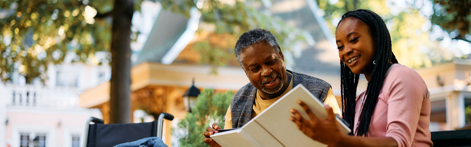 aide and elderly man looking at the photo album