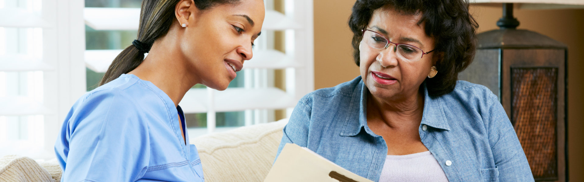 aide and elderly woman talking