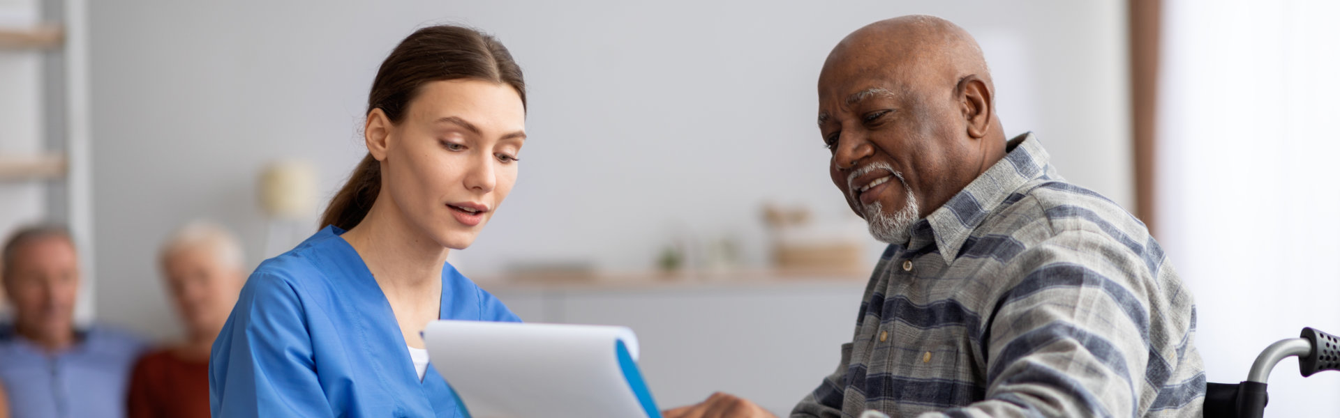 aide and elderly man talking