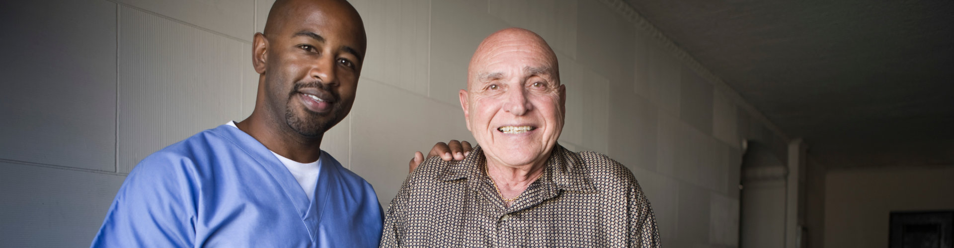 aide and elderly man smiling