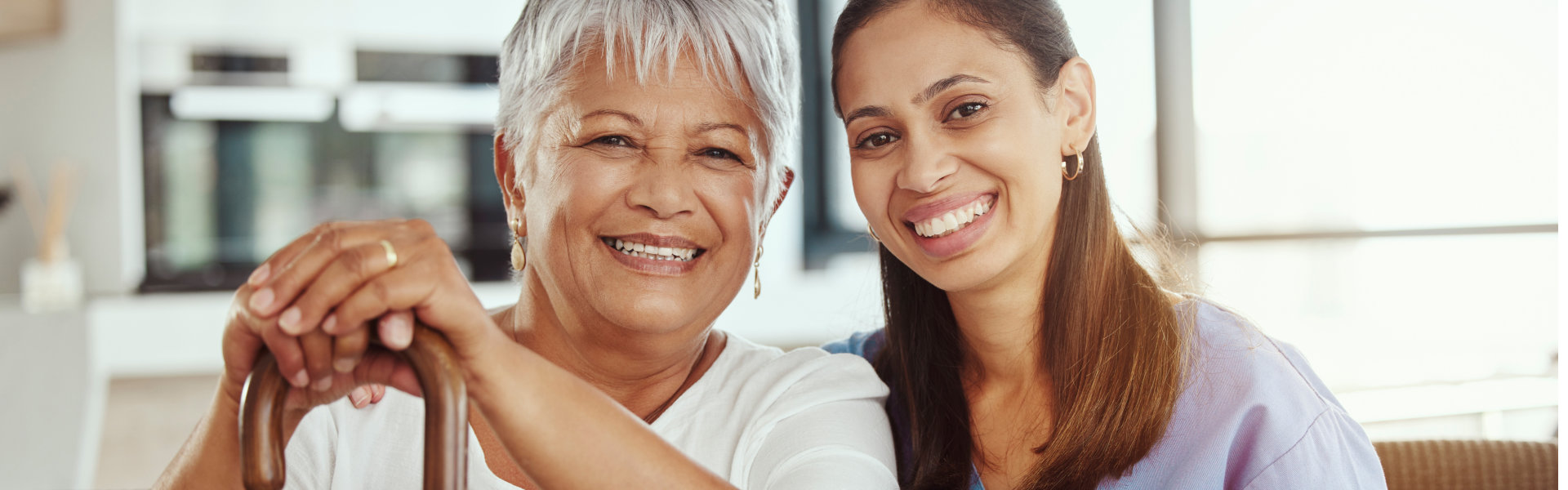 aide and elderly woman smiling